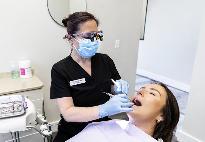 Dental hygienist cleaning a patient's teeth