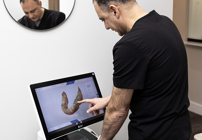 Doctor Tabbah looking at a digital scan of a patient's teeth