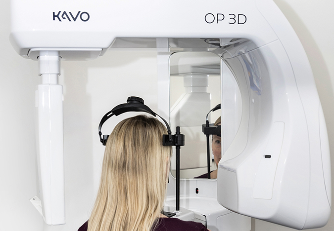 Woman getting a cone beam CT scan of her mouth and jaws