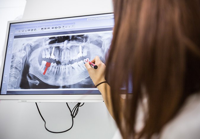 Dentist showing a patient an x-ray of their teeth