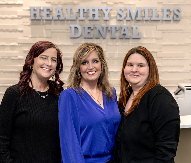 Three smiling team members at Healthy Smiles Dental