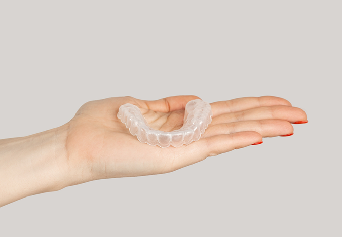 Hand holding a clear nightguard
